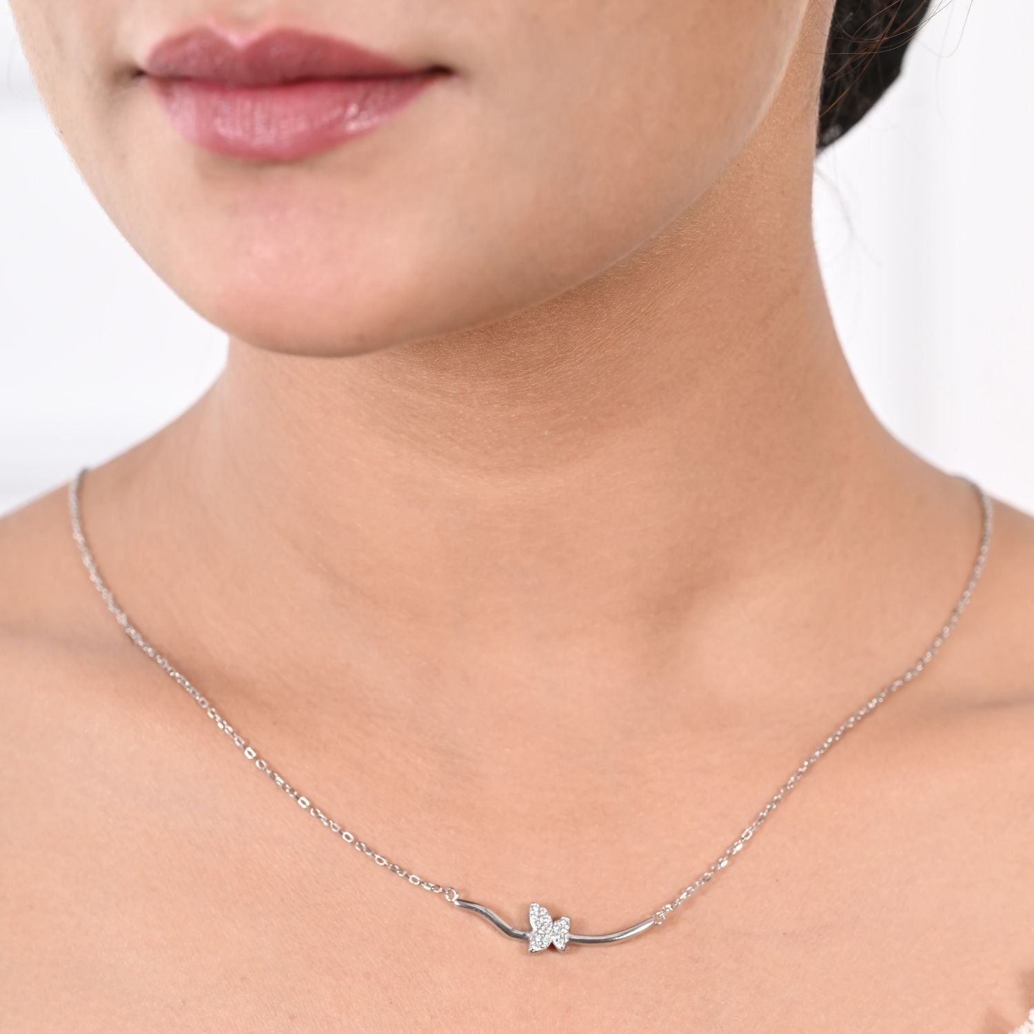 Curved-bar pendant necklace with an angel-wing charm